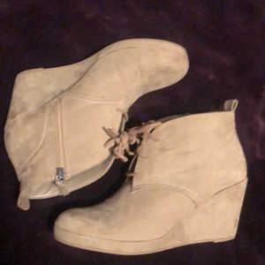 Tan high heel boots.